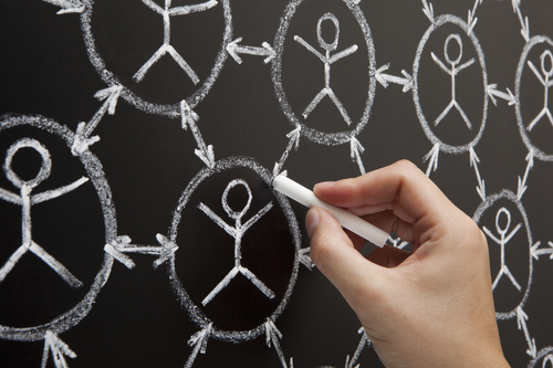 Hand showing social networking concept made with white chalk on a blackboard